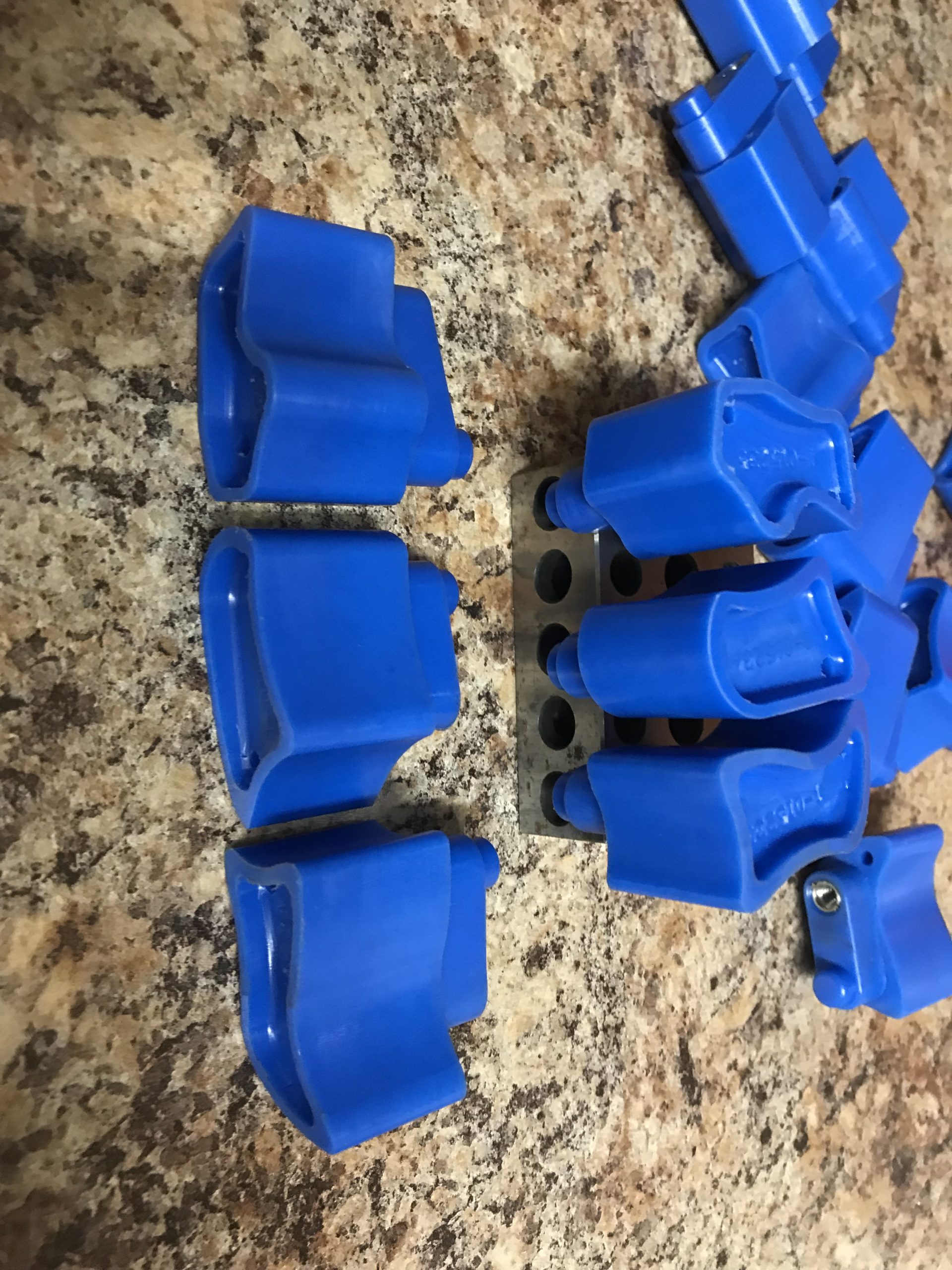Close-up of blue interlocking plastic bricks on a speckled countertop.